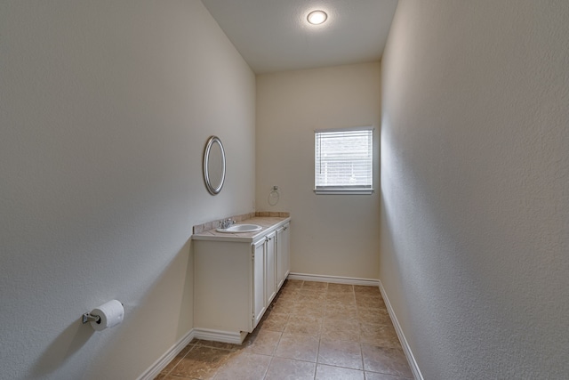 208 Cobblestone Cir, Red Oak, TX 75154 - laundry area with baseboards, light tile patterned flooring, and a sink