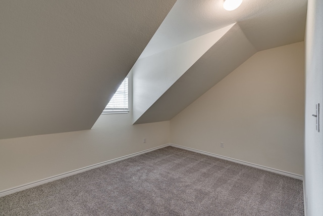 208 Cobblestone Cir, Red Oak, TX 75154 - additional living space with lofted ceiling, baseboards, and carpet