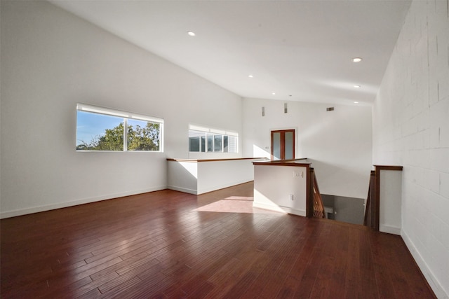 unfurnished room with lofted ceiling and dark hardwood / wood-style flooring