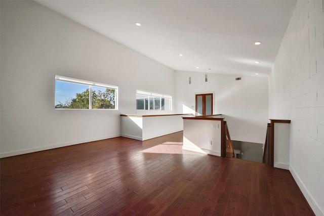 spare room featuring lofted ceiling, wood finished floors, and recessed lighting
