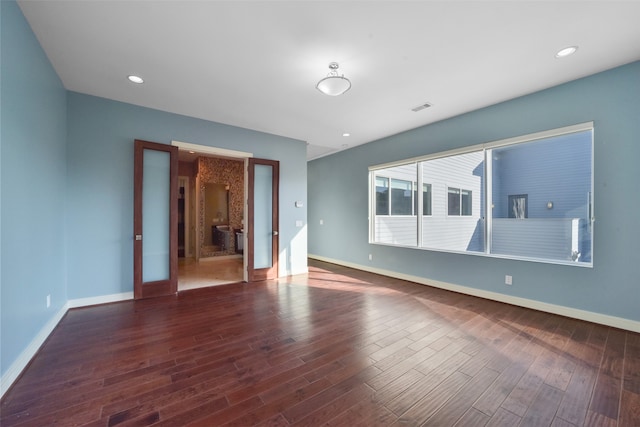 unfurnished room with dark wood-type flooring