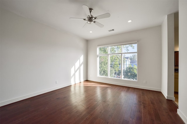 empty room with dark hardwood / wood-style floors and ceiling fan