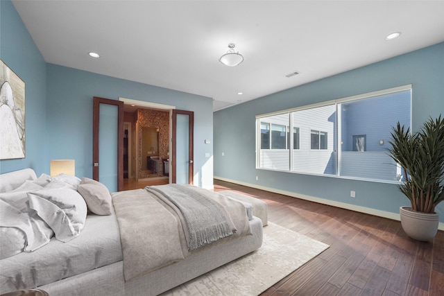 bedroom featuring visible vents, baseboards, wood finished floors, and recessed lighting