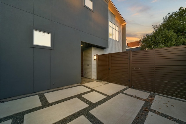 patio terrace at dusk with a gate and fence