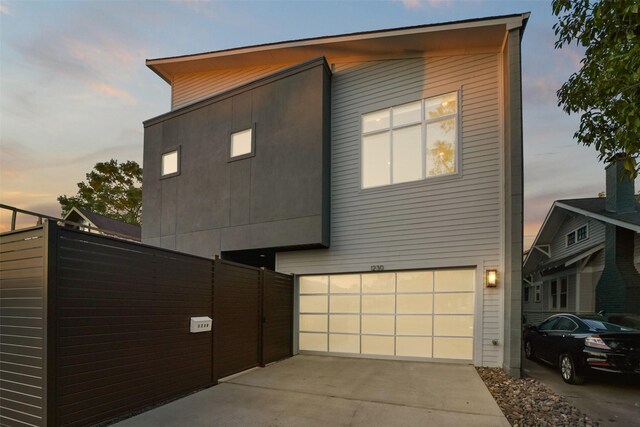 view of property exterior featuring a garage and driveway