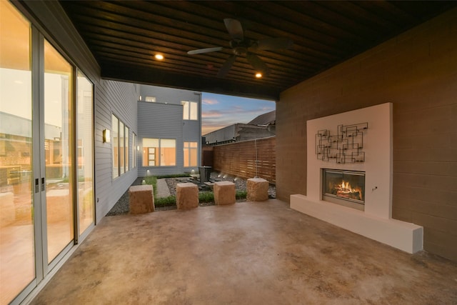 patio terrace at dusk featuring ceiling fan