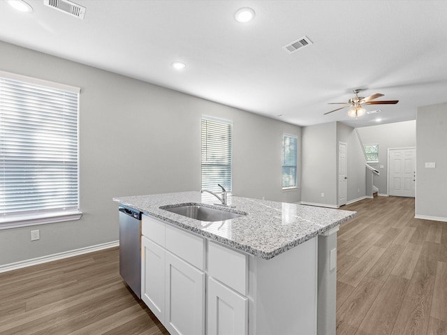 kitchen featuring sink, white cabinets, light stone counters, ceiling fan, and stainless steel dishwasher