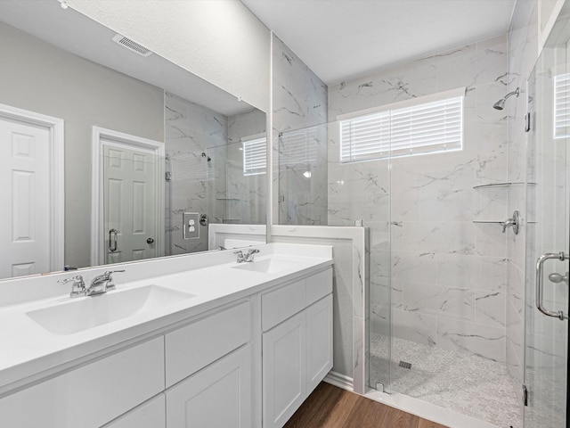 bathroom with an enclosed shower, vanity, and hardwood / wood-style floors