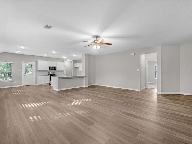 unfurnished living room with light hardwood / wood-style floors and ceiling fan