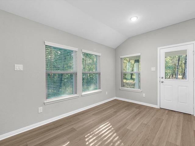 entrance foyer with light hardwood / wood-style floors and vaulted ceiling