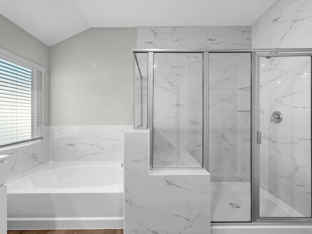 bathroom with shower with separate bathtub, wood-type flooring, and vaulted ceiling