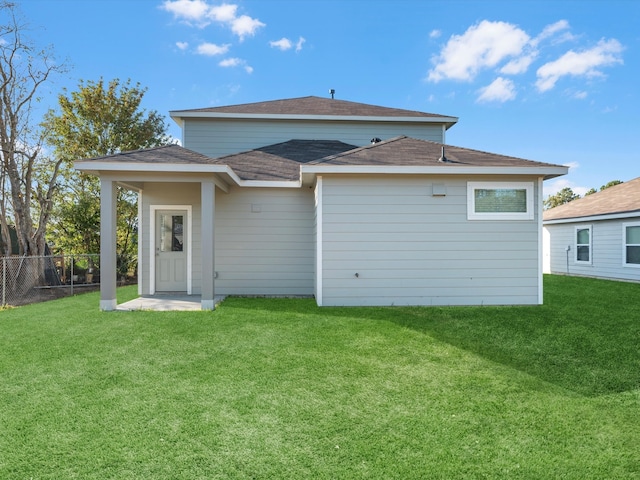 back of property featuring a lawn