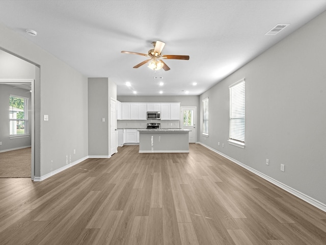 unfurnished living room with light hardwood / wood-style floors and ceiling fan