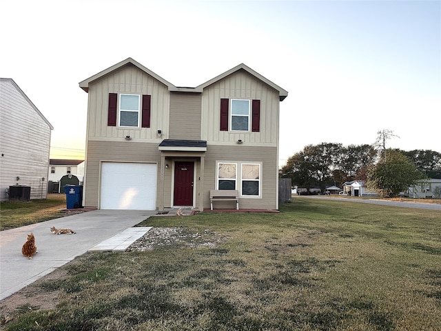 view of front of house featuring a front lawn, central AC unit, and a garage