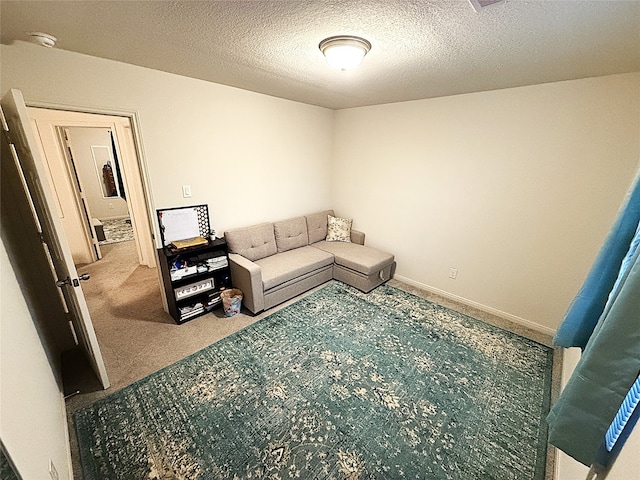 living room featuring carpet and a textured ceiling