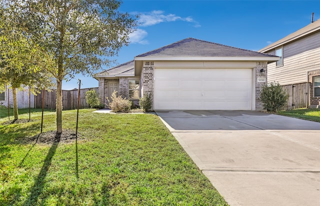 ranch-style house featuring a front lawn and a garage