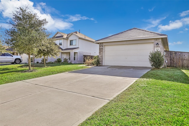 view of front of property with a garage and a front lawn