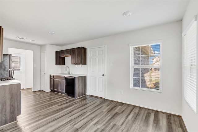 kitchen featuring dishwasher, light wood-type flooring, sink, and stainless steel refrigerator