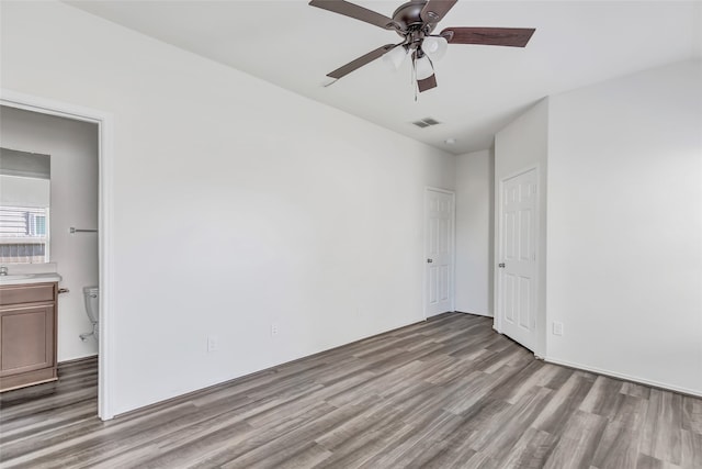 spare room with ceiling fan and light hardwood / wood-style floors