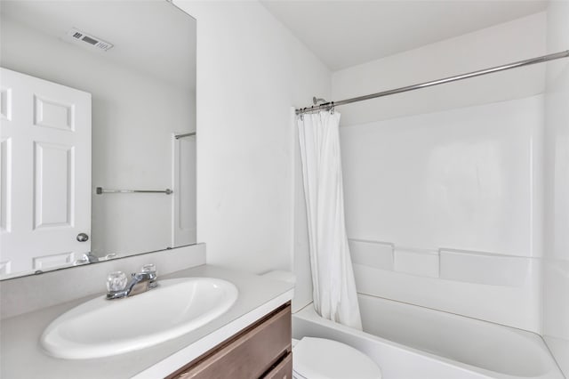 full bathroom featuring shower / tub combo, vanity, and toilet