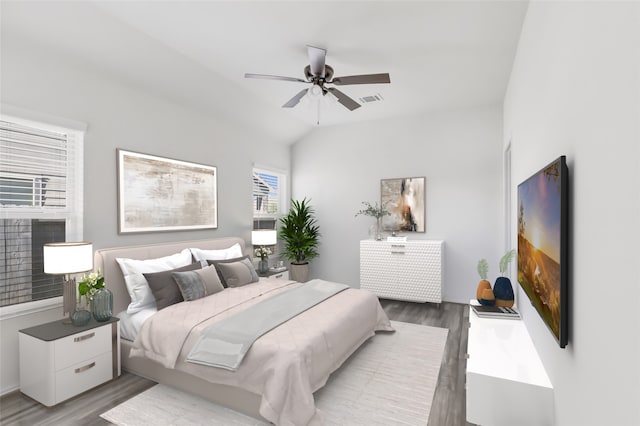 bedroom with ceiling fan, hardwood / wood-style floors, and lofted ceiling