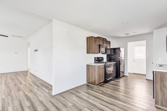 kitchen featuring black appliances and light wood-type flooring