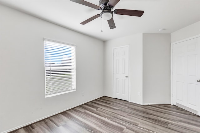 unfurnished bedroom with ceiling fan and light wood-type flooring