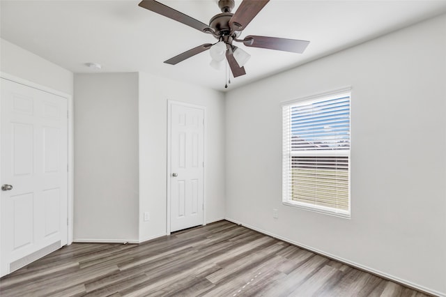 unfurnished bedroom featuring hardwood / wood-style flooring and ceiling fan