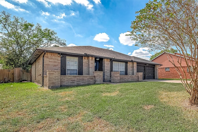 view of front of property featuring a front yard and a garage