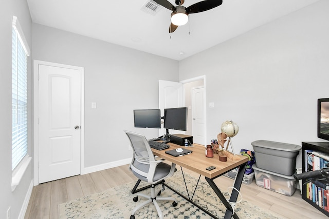 office space with light wood-type flooring and ceiling fan