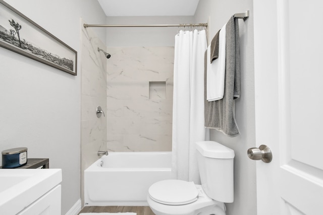 full bathroom featuring vanity, shower / tub combo, and toilet