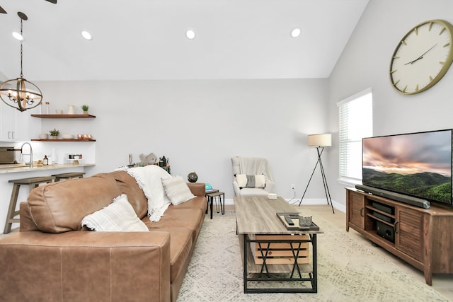 living room featuring vaulted ceiling and a notable chandelier