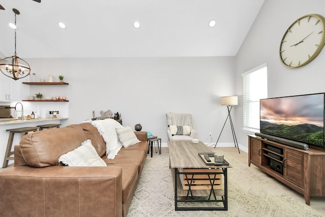 living area featuring baseboards, recessed lighting, a notable chandelier, and lofted ceiling
