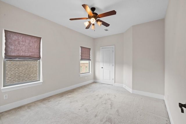 carpeted empty room featuring ceiling fan