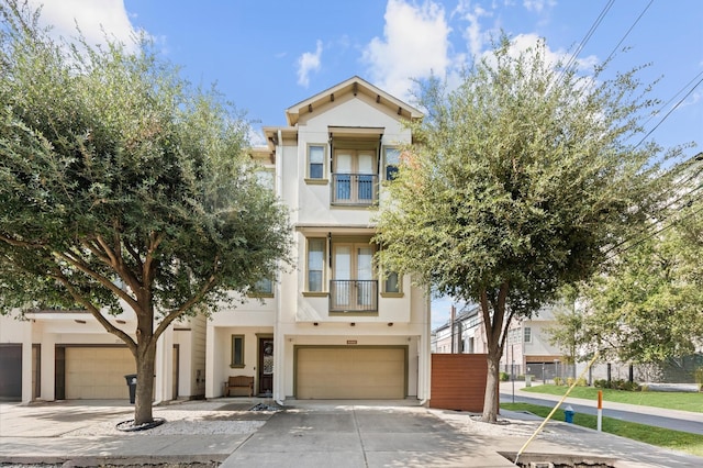 view of front of property with a balcony and a garage