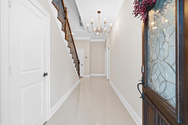 foyer entrance with crown molding, light tile patterned flooring, and a chandelier