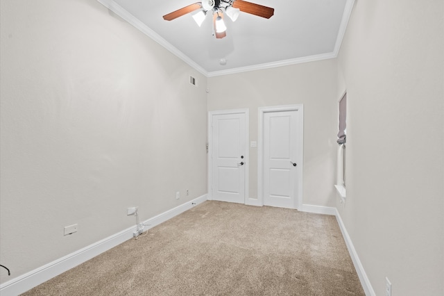 carpeted empty room featuring crown molding and ceiling fan