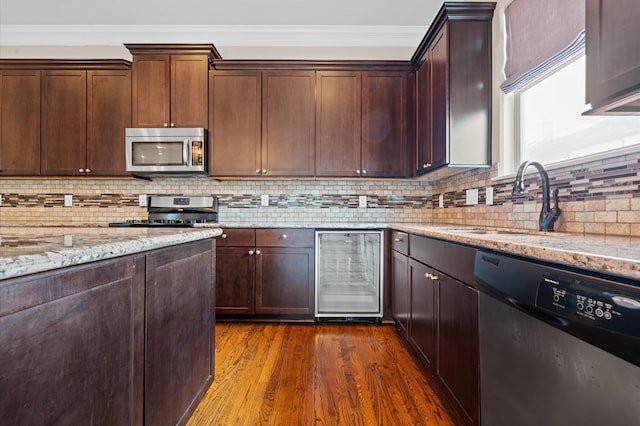 kitchen featuring wine cooler, dark wood-type flooring, sink, stainless steel appliances, and light stone countertops