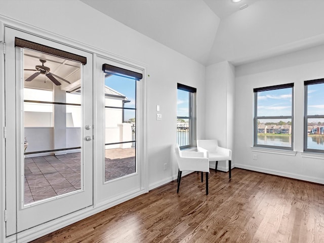 interior space featuring french doors, lofted ceiling, a ceiling fan, wood finished floors, and baseboards