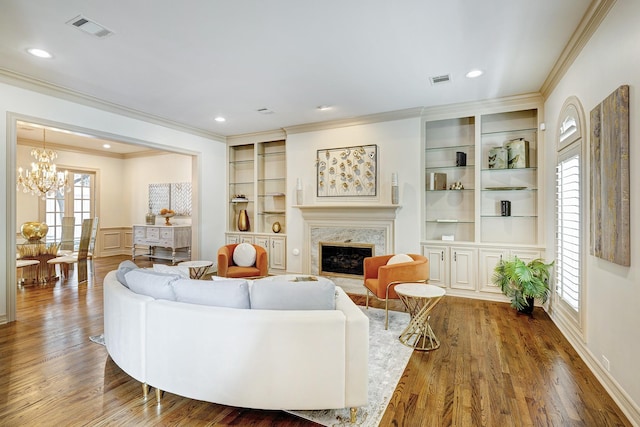5120 Tangle Ln, Houston, TX 77056 - living area with a chandelier, ornamental molding, wood finished floors, a high end fireplace, and recessed lighting