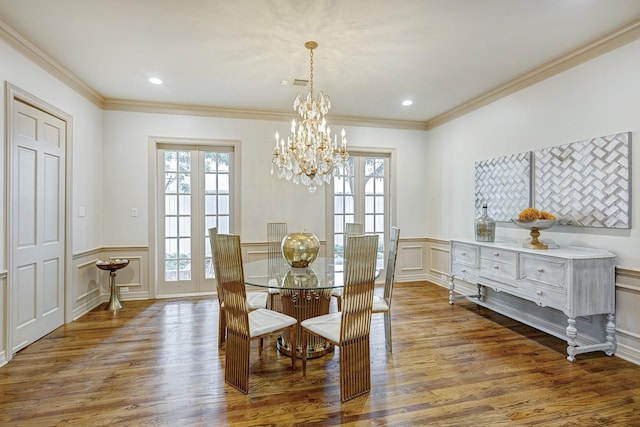 dining space with hardwood / wood-style flooring, crown molding, and a wealth of natural light