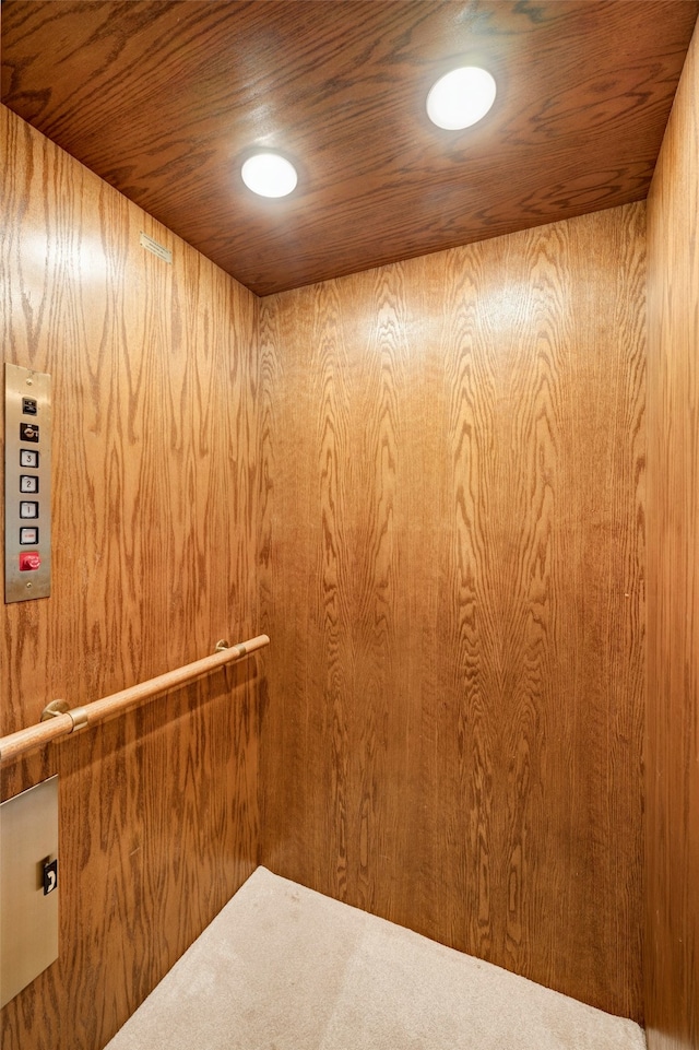 interior details featuring wood ceiling and elevator