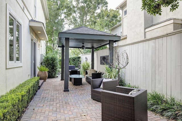 view of patio featuring outdoor lounge area, a gazebo, and ceiling fan