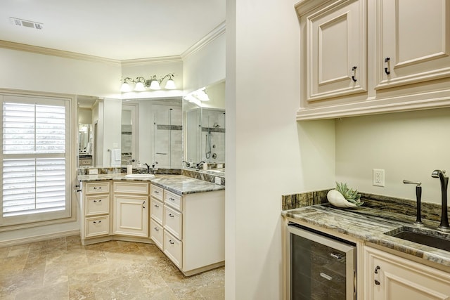 bathroom featuring plenty of natural light, vanity, crown molding, and beverage cooler