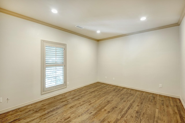 unfurnished room with hardwood / wood-style floors and crown molding