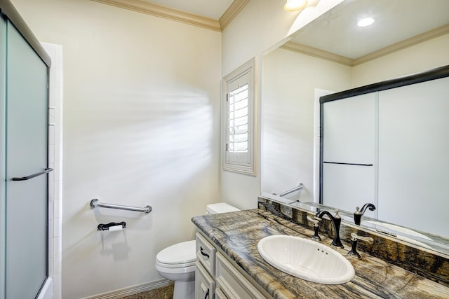 bathroom with crown molding, vanity, an enclosed shower, and toilet