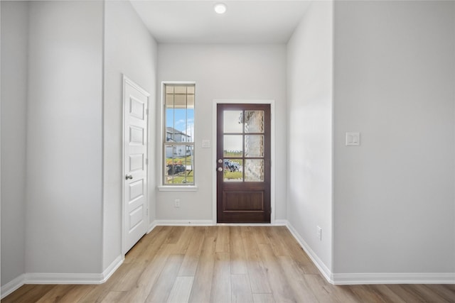 entryway featuring light wood-type flooring and baseboards