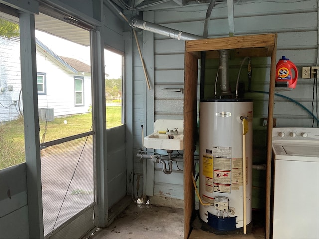 utilities with washer / clothes dryer, sink, and gas water heater