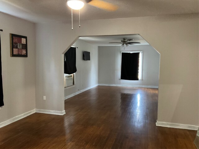 interior space with dark wood-type flooring and ceiling fan