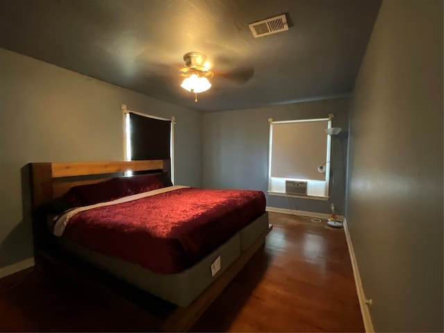 bedroom with dark wood-type flooring and ceiling fan